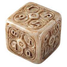 Ancient carved dice on a stone surface